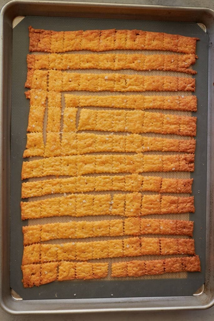 Freshly baked sourdough cheez it's on a sheet pan.