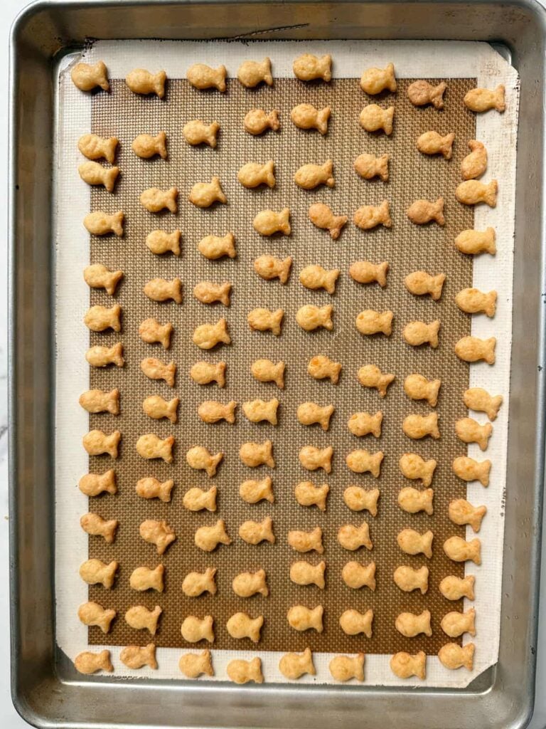 Freshly baked Sourdough Goldfish on a sheet pan.