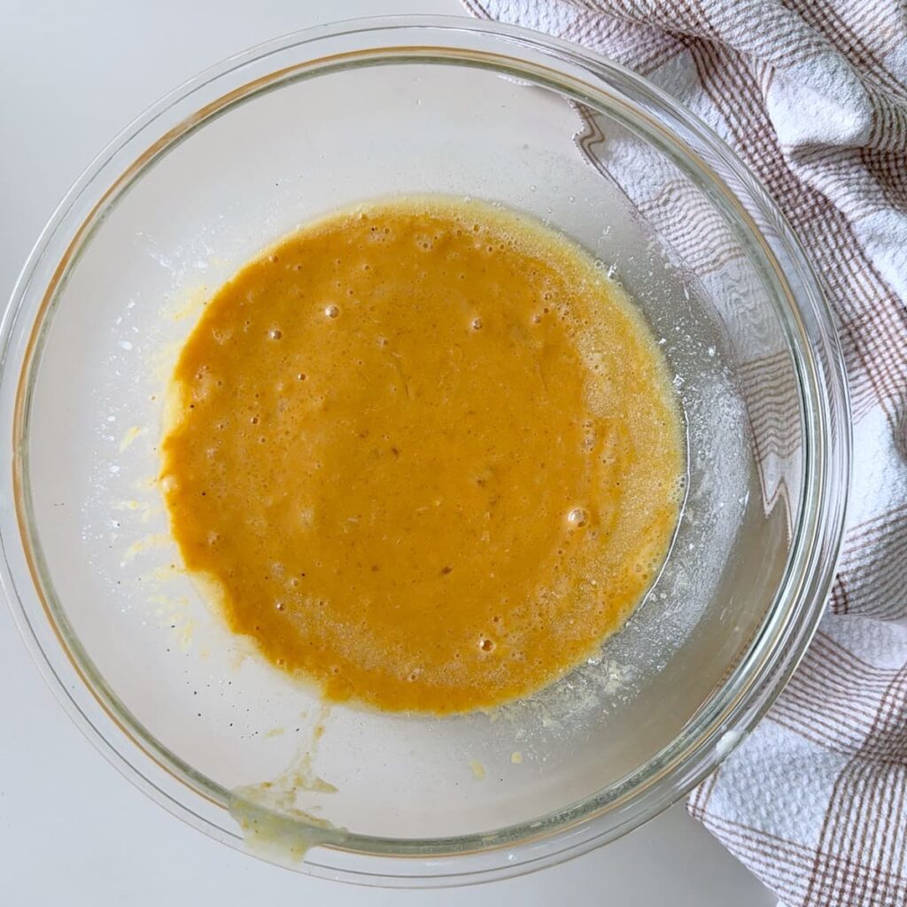 Wet Ingredients for sourdough pumpkin mini muffins in a clear bowl.