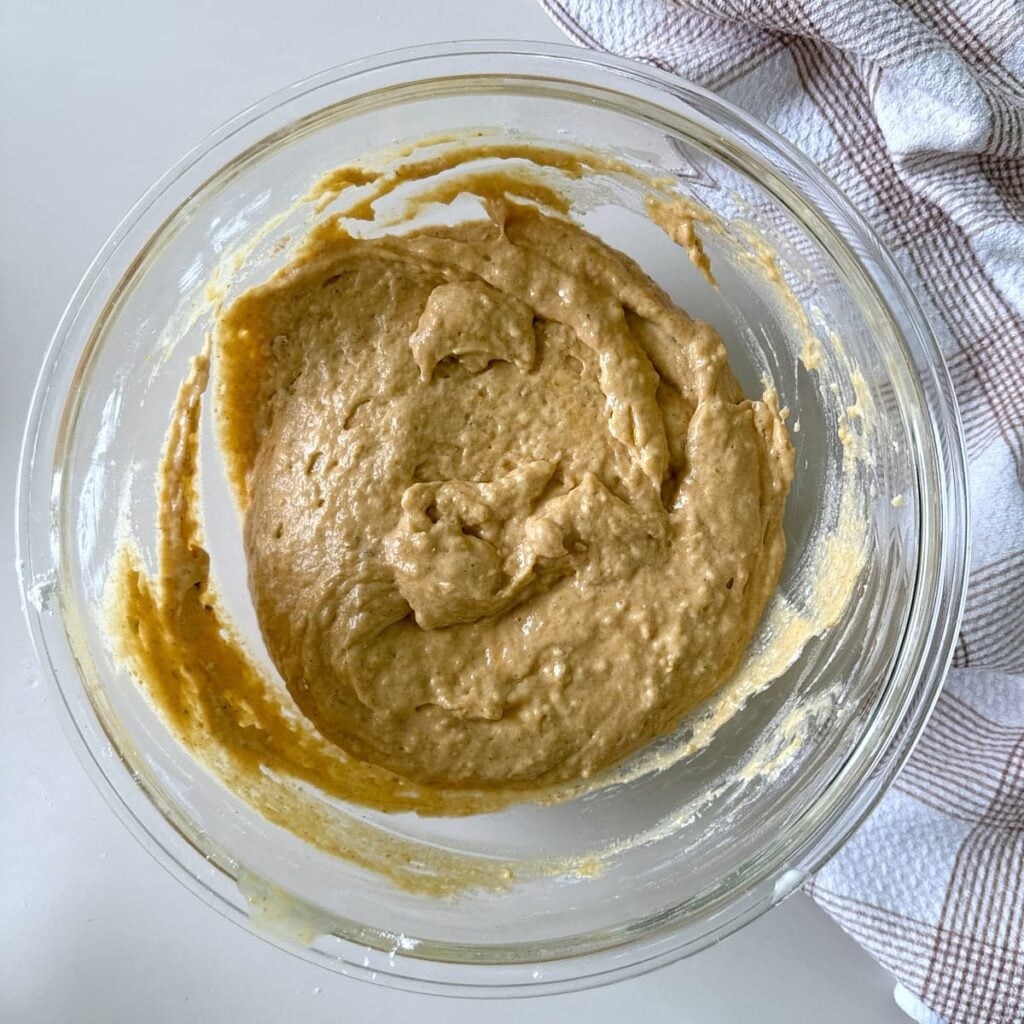 Dry ingredients added to batter for sourdough pumpkin mini muffins.
