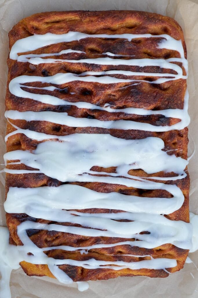 Icing drizzled over freshly baked Sourdough Pumpkin Focaccia.