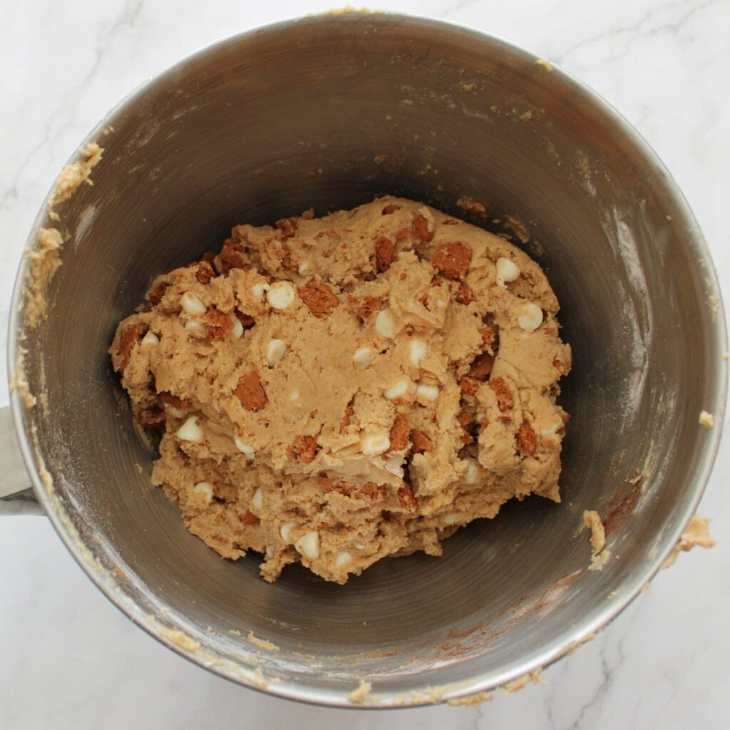 White chocolate chips and crumbled biscoff cookies folded into cookie dough.