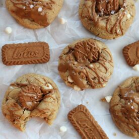 Cookie butter sourdough cookies next to Biscoff cookies and white chocolate chips.