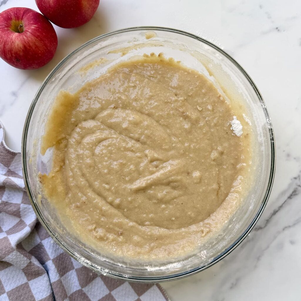Batter for Sourdough Discard Apple Cake Mixed together in a clear bowl.