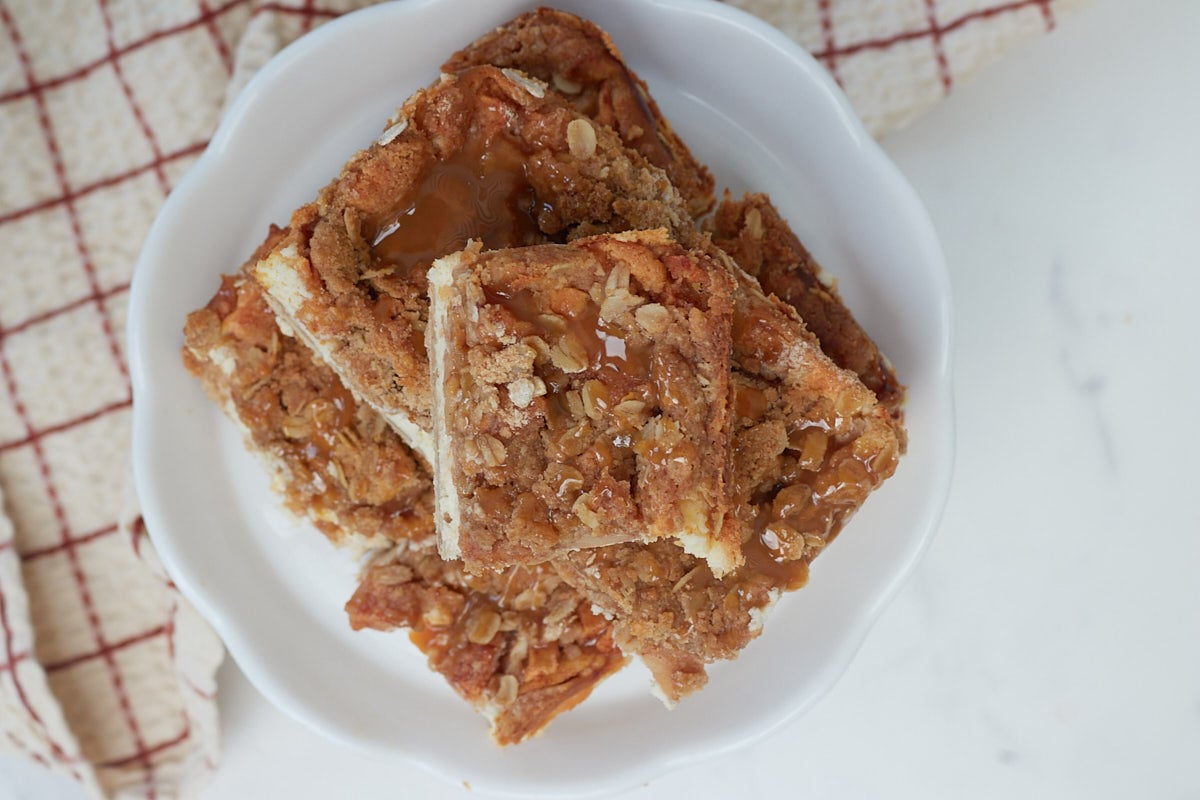 Overhead view of Sourdough Apple Cheesecake Bars on a white stand.