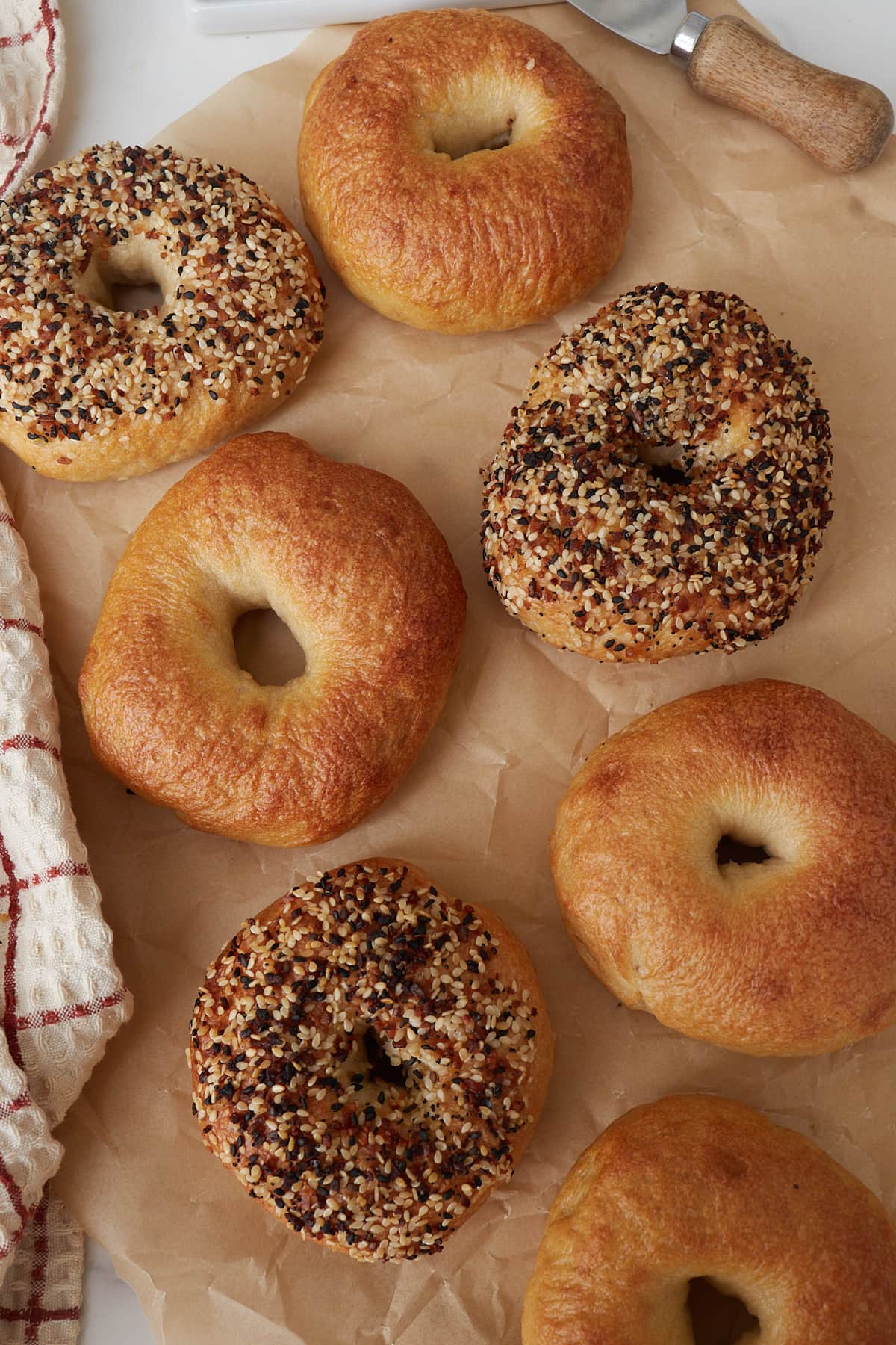 Sourdough Bagels on brown parchment paper.