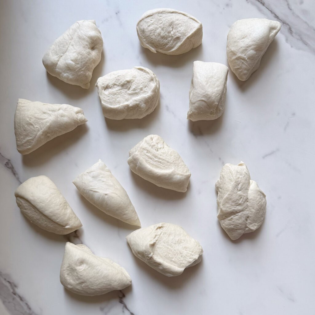 Dough for Sourdough Bagels cut into 12 equal pieces.