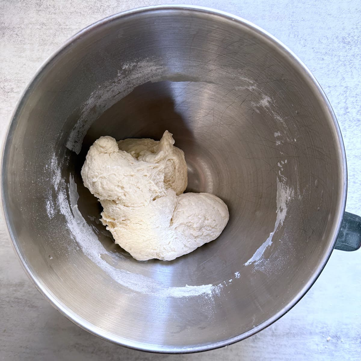 Sourdough breadstick dough in a metal stand mixer bowl.