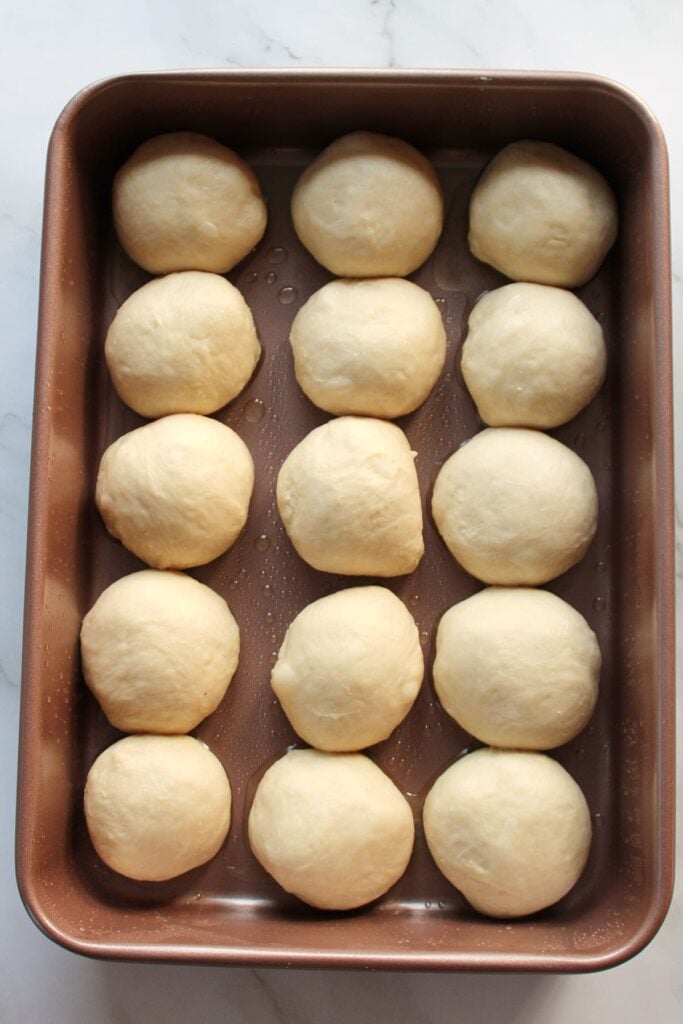 Sourdough dinner rolls before the second rise in a 9x13 pan.