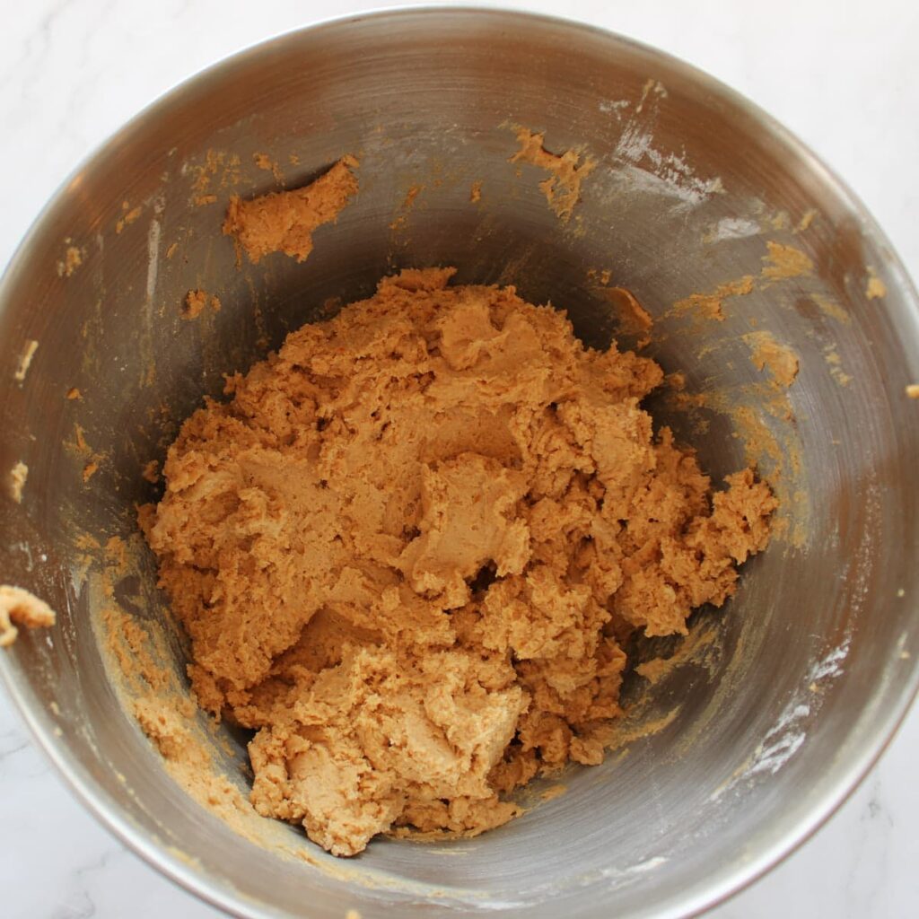 Dry ingredients added to cookie dough for Sourdough Pumpkin Snickerdoodles.