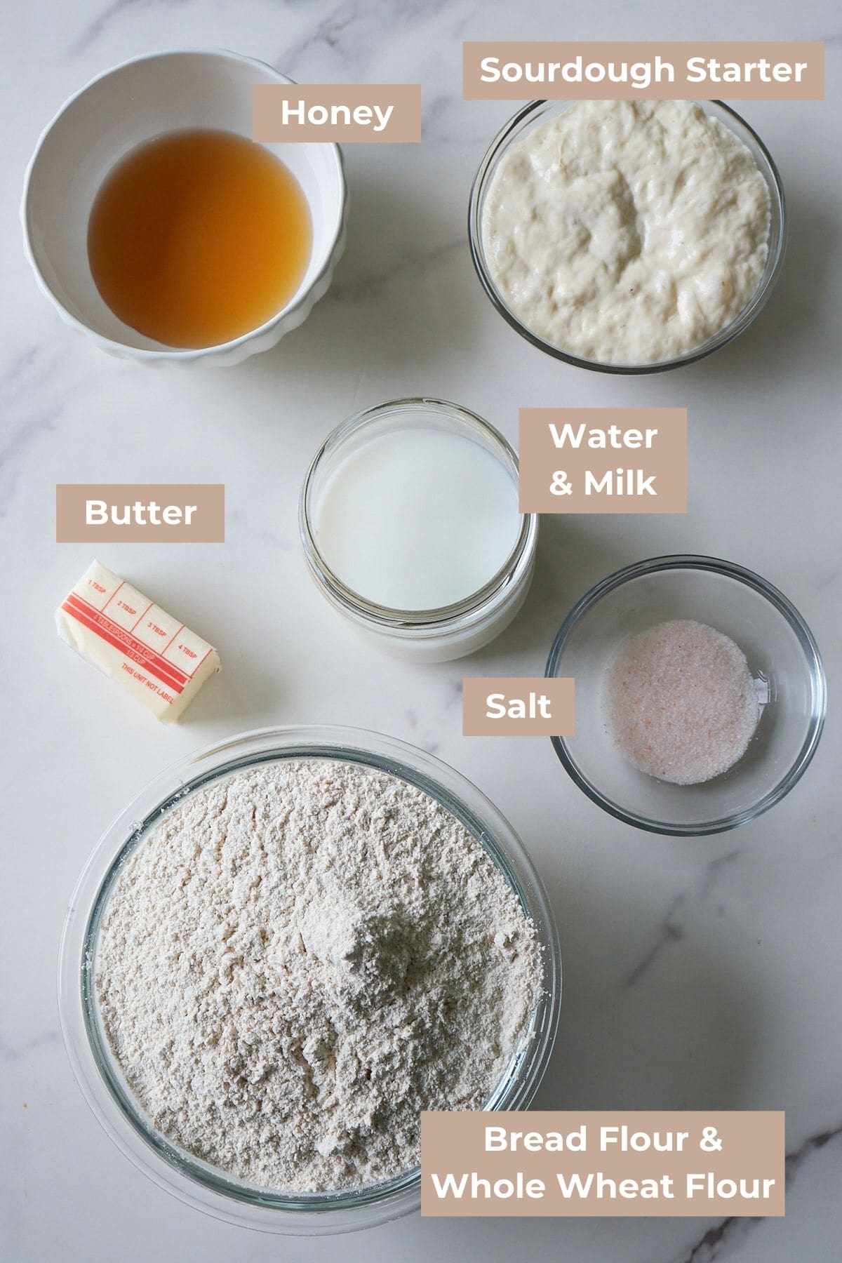 Ingredients for Sourdough Sandwich Bread in clear bowls.