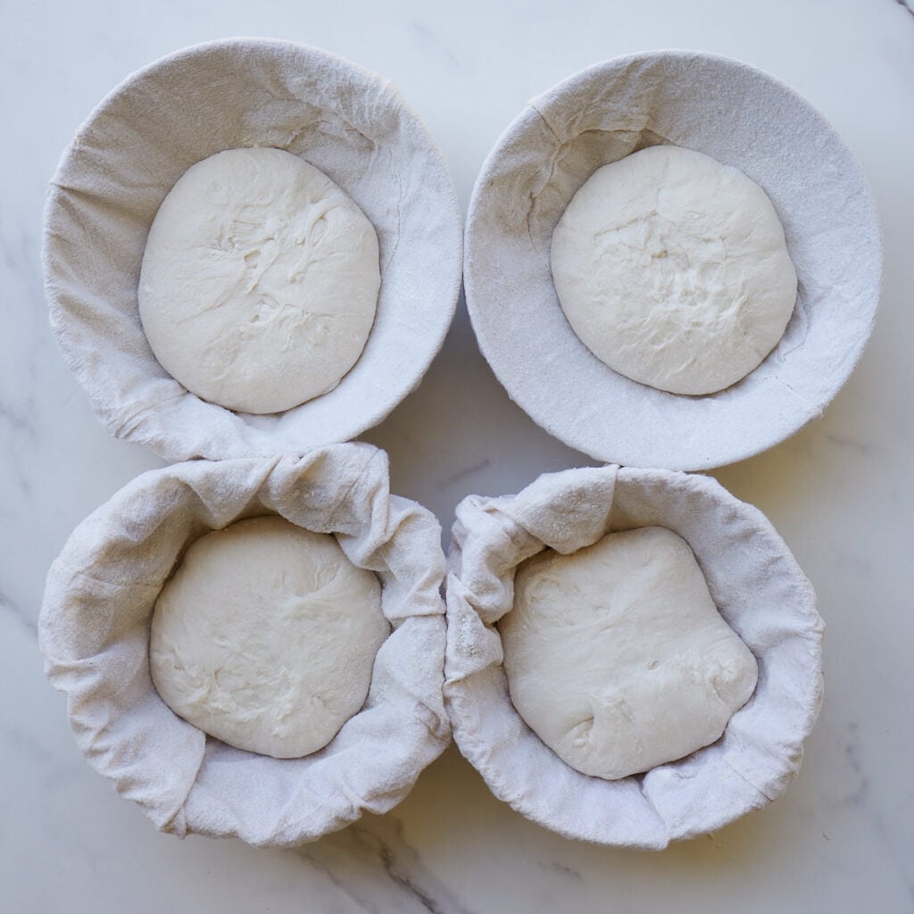 Sourdough bread bowls proofing in lined cereal bowls.