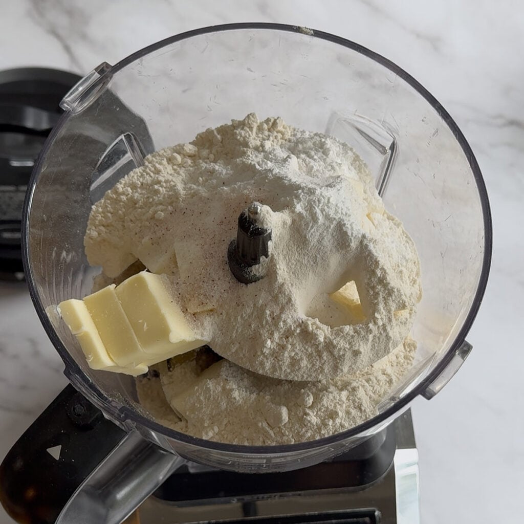 Butter, flour, salt and baking powder added to a food processor to make Sourdough Cheddar Biscuits.