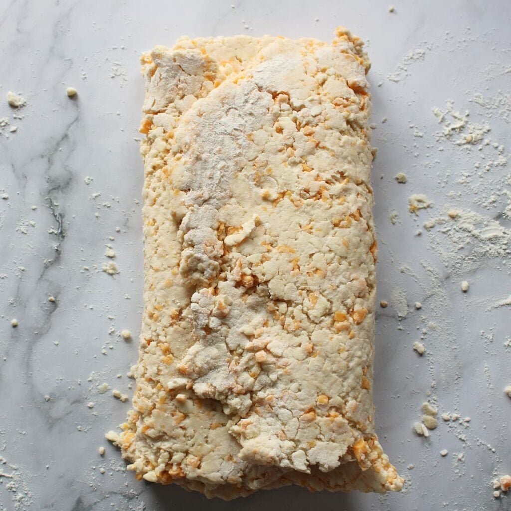 Sourdough Cheddar Biscuit dough folded like a trifold.