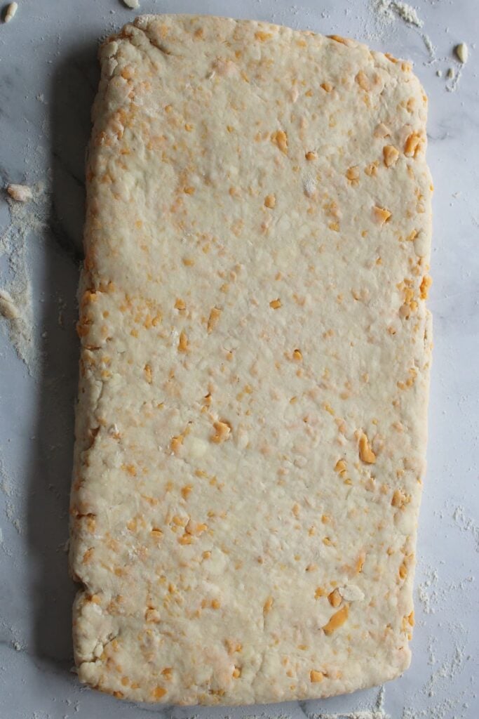 Sourdough Cheddar Biscuit dough in a 6x12-inch rectangle.