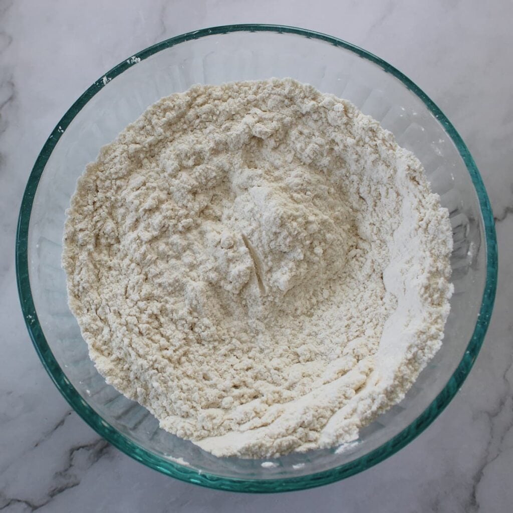 Dry ingredients mixed together in a clear bowl for sourdough coffee cake.