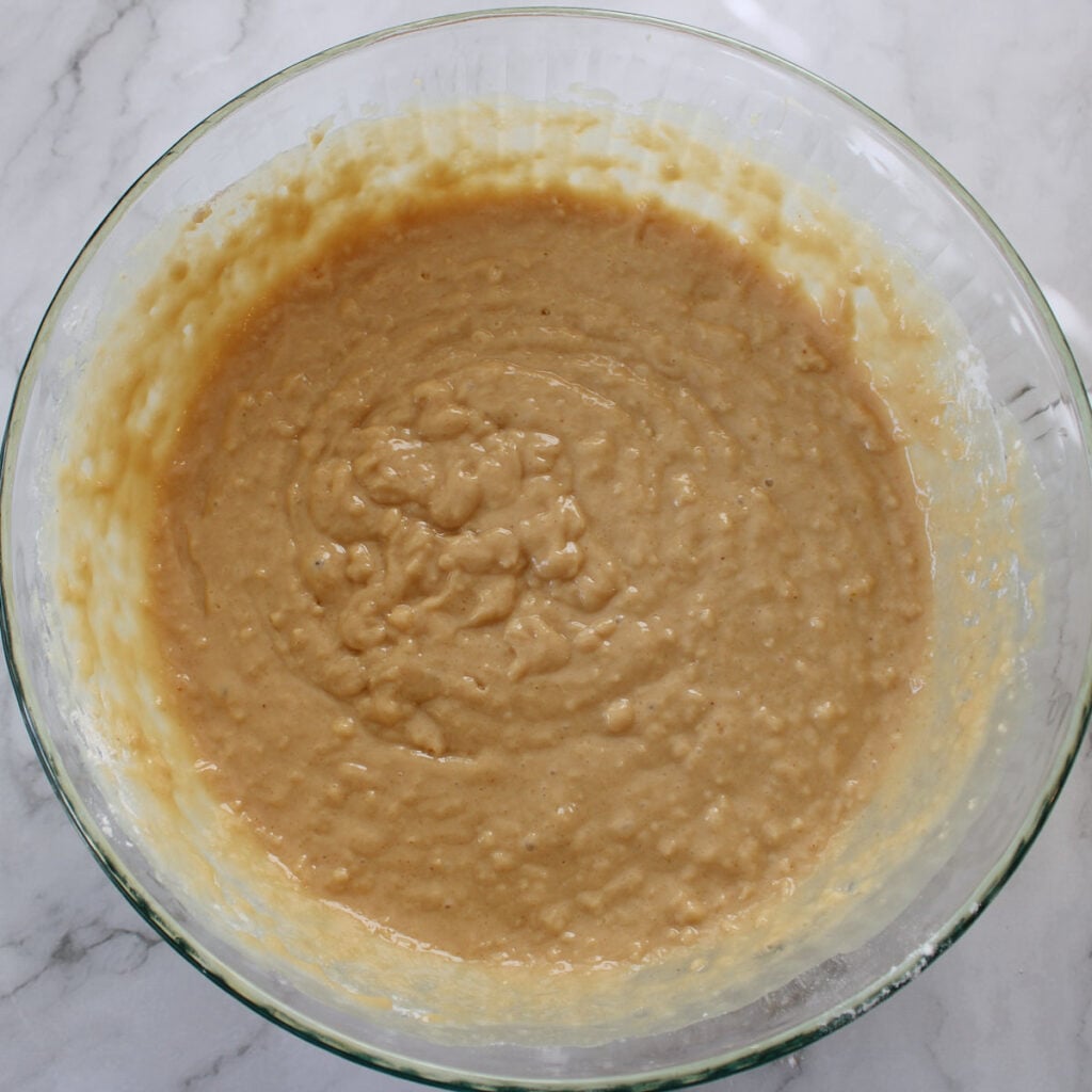 Batter for sourdough coffee cake in a clear bowl.