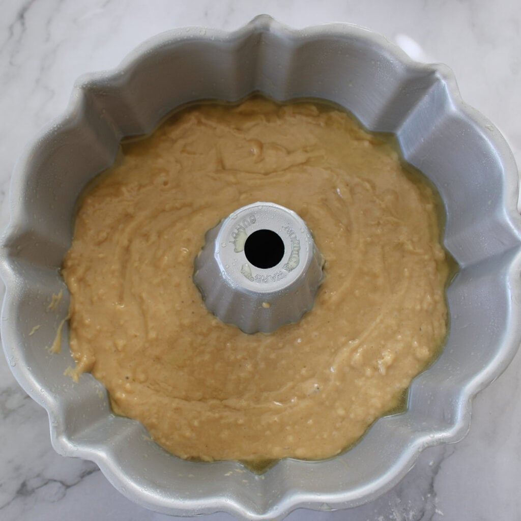First layer of batter for sourdough coffee cake added to a bundt pan.