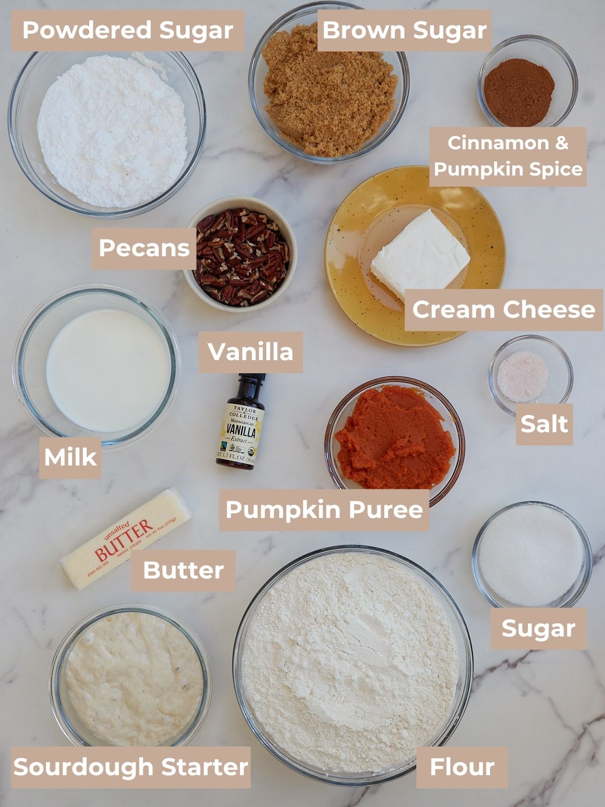 Ingredients for sourdough pumpkin cinnamon rolls in clear bowls.