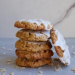 Sourdough Oatmeal Cookies stacked on top of each other with one leaning against the stack.