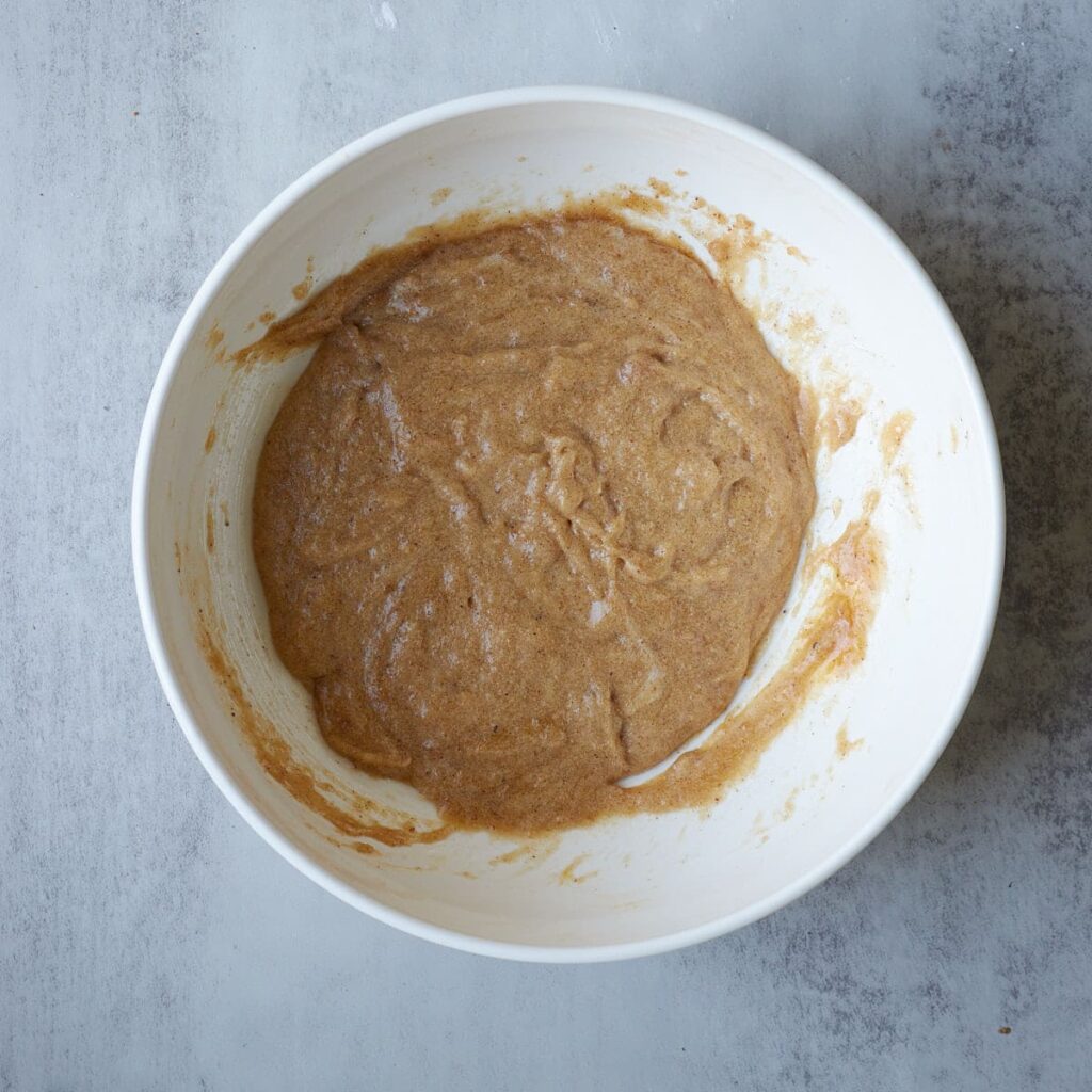 Wet ingredients for Sourdough Oatmeal Cookies in a white bowl.