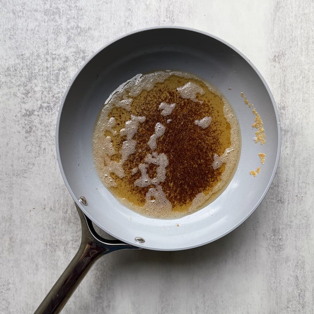 Brown butter in a small pan for Sourdough Oatmeal Cookies.