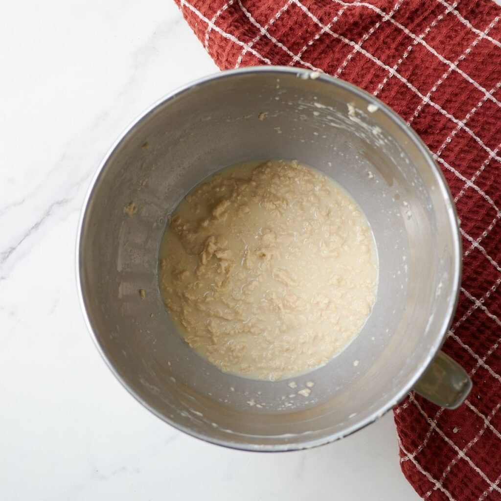 Wet ingredients for Sourdough Apple Fritter Bread added to the creamed butter and sugar.