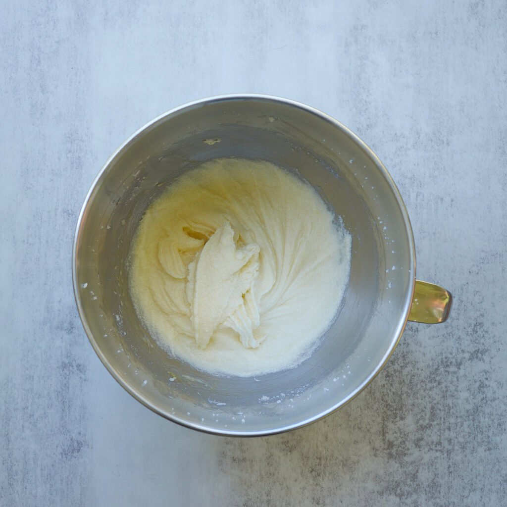 Eggs added to the creamed butter and sugar for sourdough chocolate cake.
