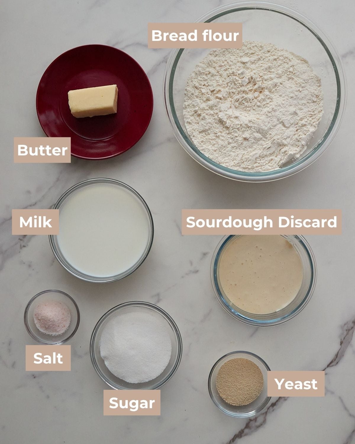 Ingredients for Sourdough Discard Dinner Rolls in clear bowls on a white background.