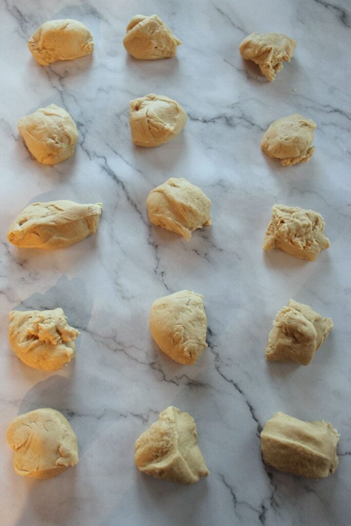 Sourdough Discard Hawaiian Roll dough divided into 15 equal pieces.
