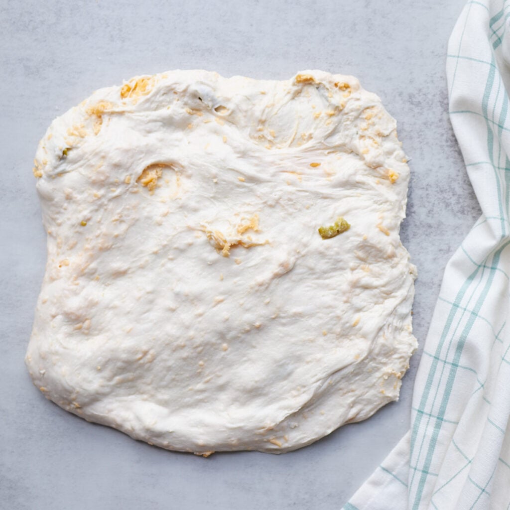 Jalape&ntilde;o Cheddar Sourdough Bread dough shaped in a chubby rectangle.