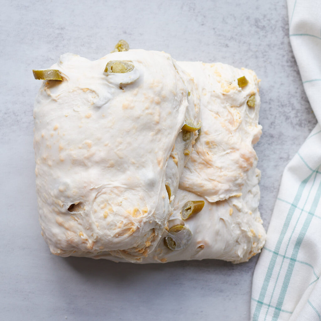 Dough for Jalape&ntilde;o Cheddar Sourdough Bread during the shaping process.