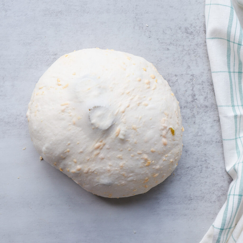 Dough for Jalape&ntilde;o Cheddar Sourdough Bread shaped into a round ball.