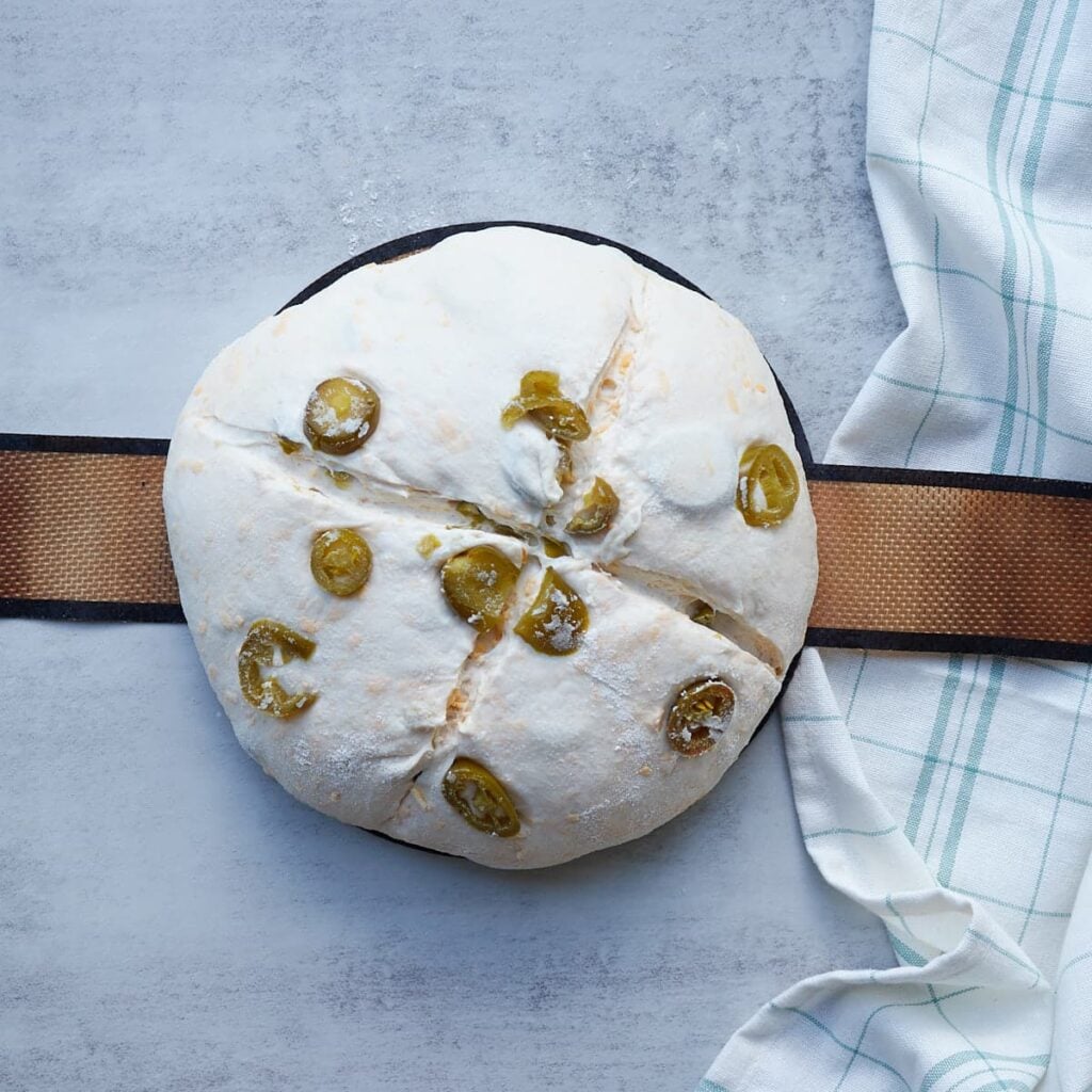 Jalape&ntilde;o Cheddar Sourdough Bread dough scored before baking.