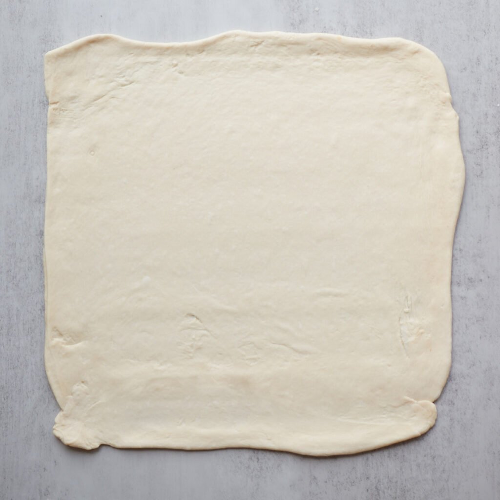 Dough for sourdough apple pie pull apart bread rolled out into a 16x16" rectangle.