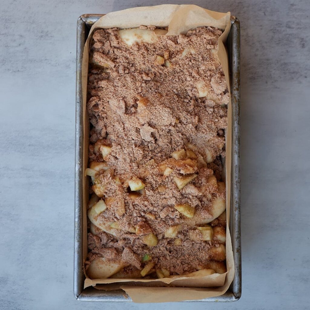 Sourdough apple pie pull apart bread in a loaf pan before baking.