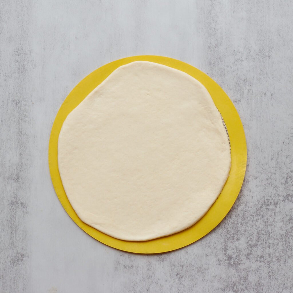 One layer of sourdough cinnamon star bread rolled out into a circle.