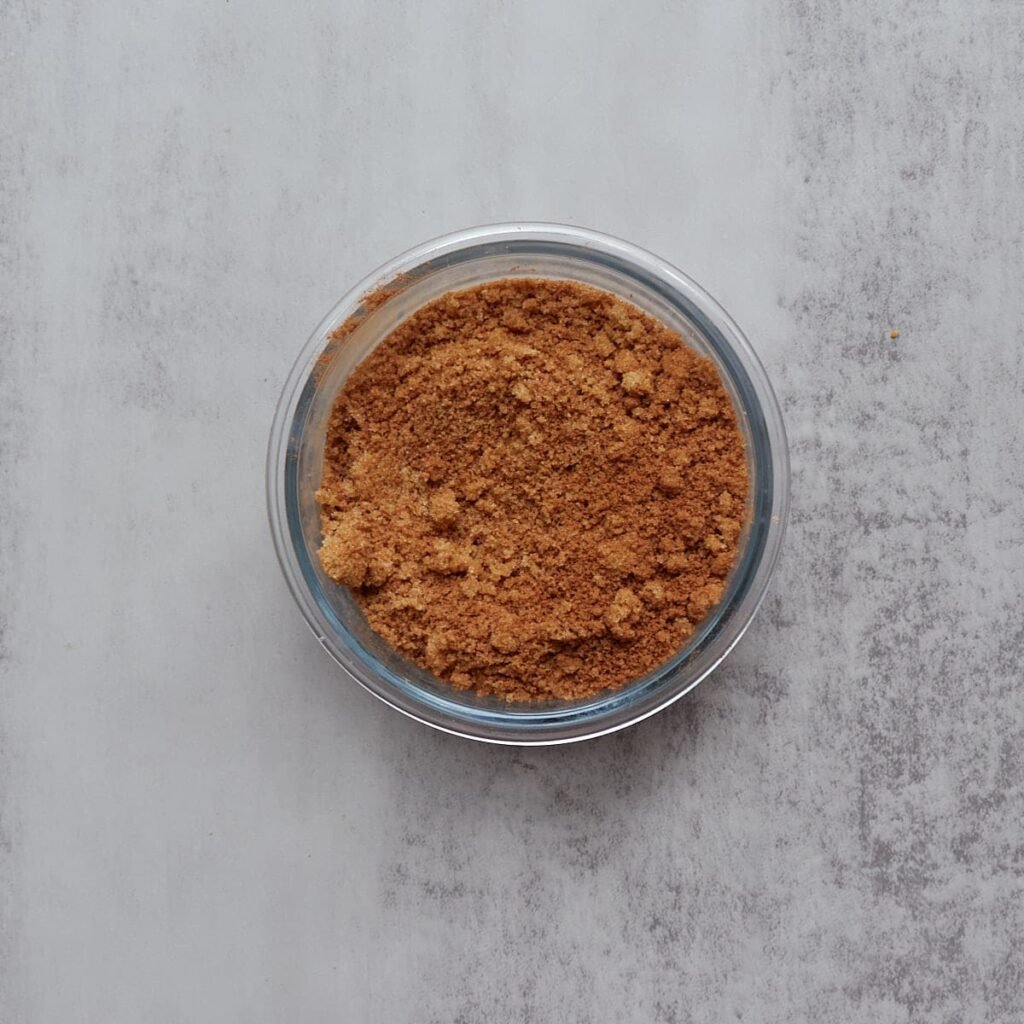 Cinnamon sugar mixture mixed together in a clear bowl for sourdough cinnamon star bread.