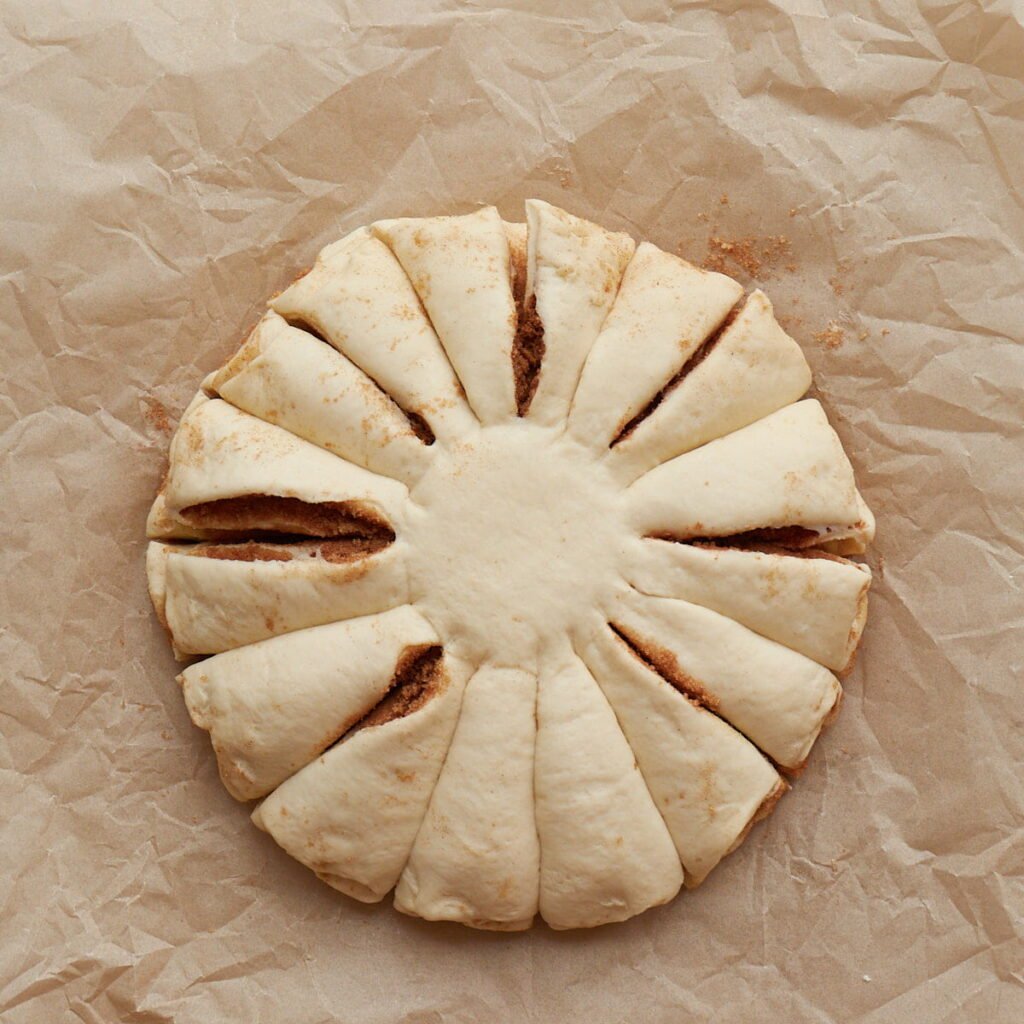 Sourdough cinnamon star bread cut into sections before twisting together.