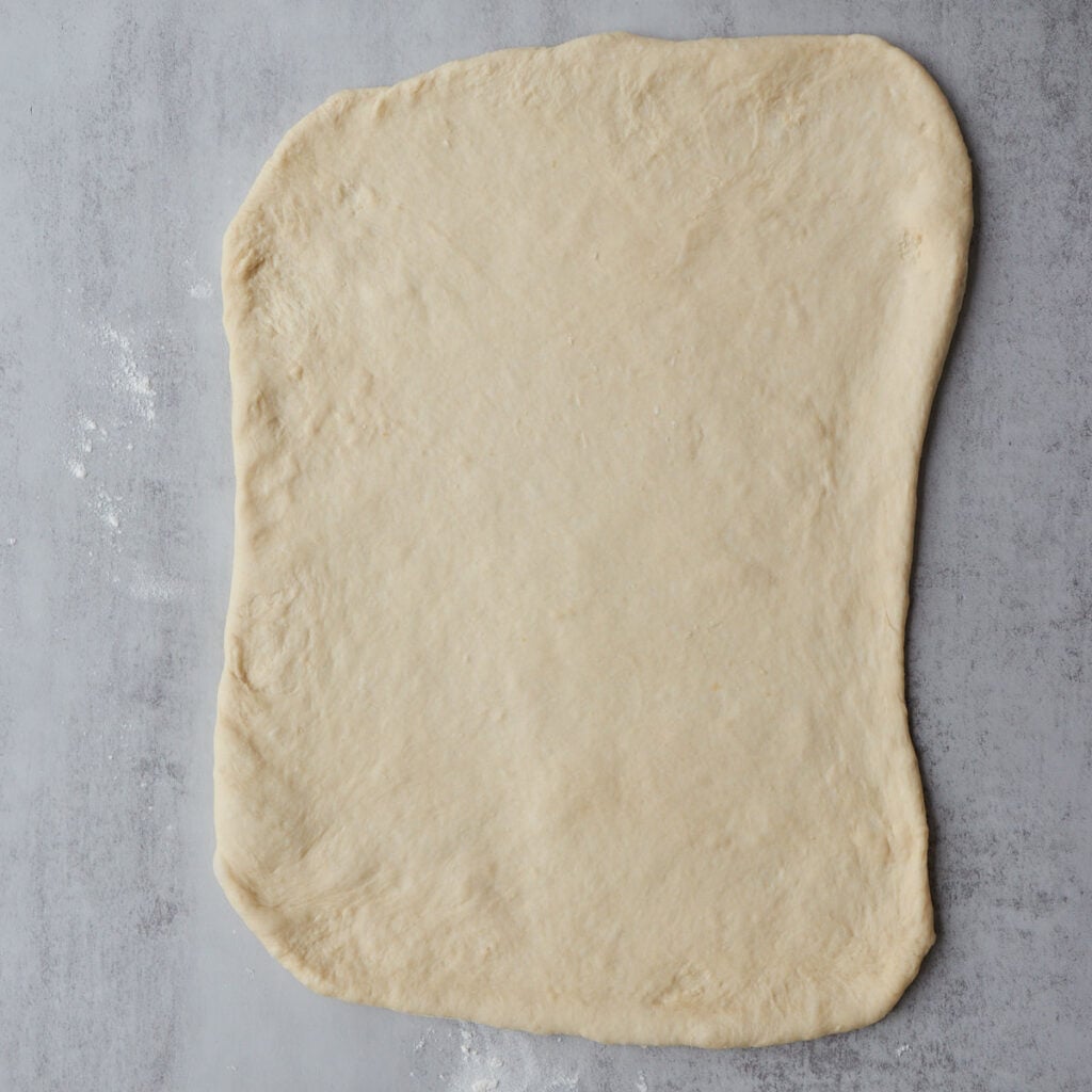 Sourdough discard cinnamon roll dough rolled out into a 11 x 18 rectangle.