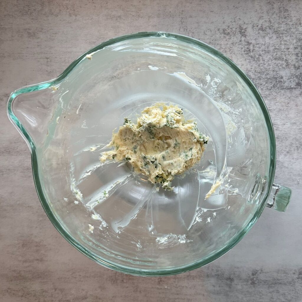 Roasted garlic butter mixed together in a clear bowl.