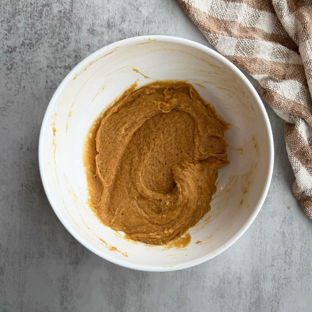 Wet ingredients added to the dough for sourdough peanut butter cookies.