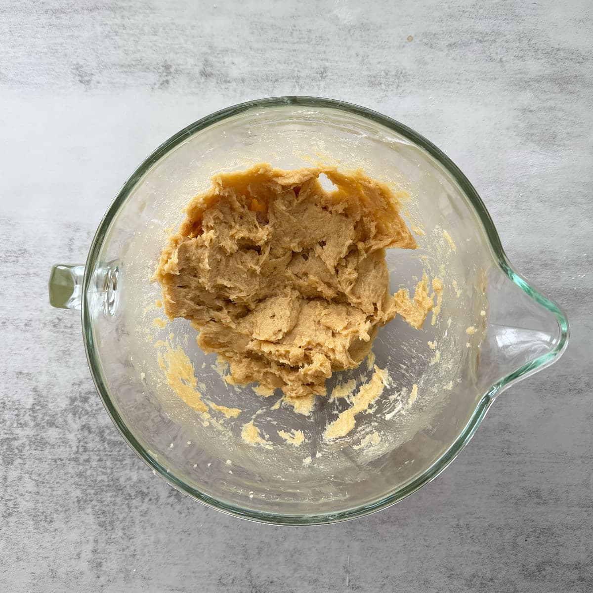 Wet ingredients for Sourdough Snickerdoodles added to creamed butter and sugar.