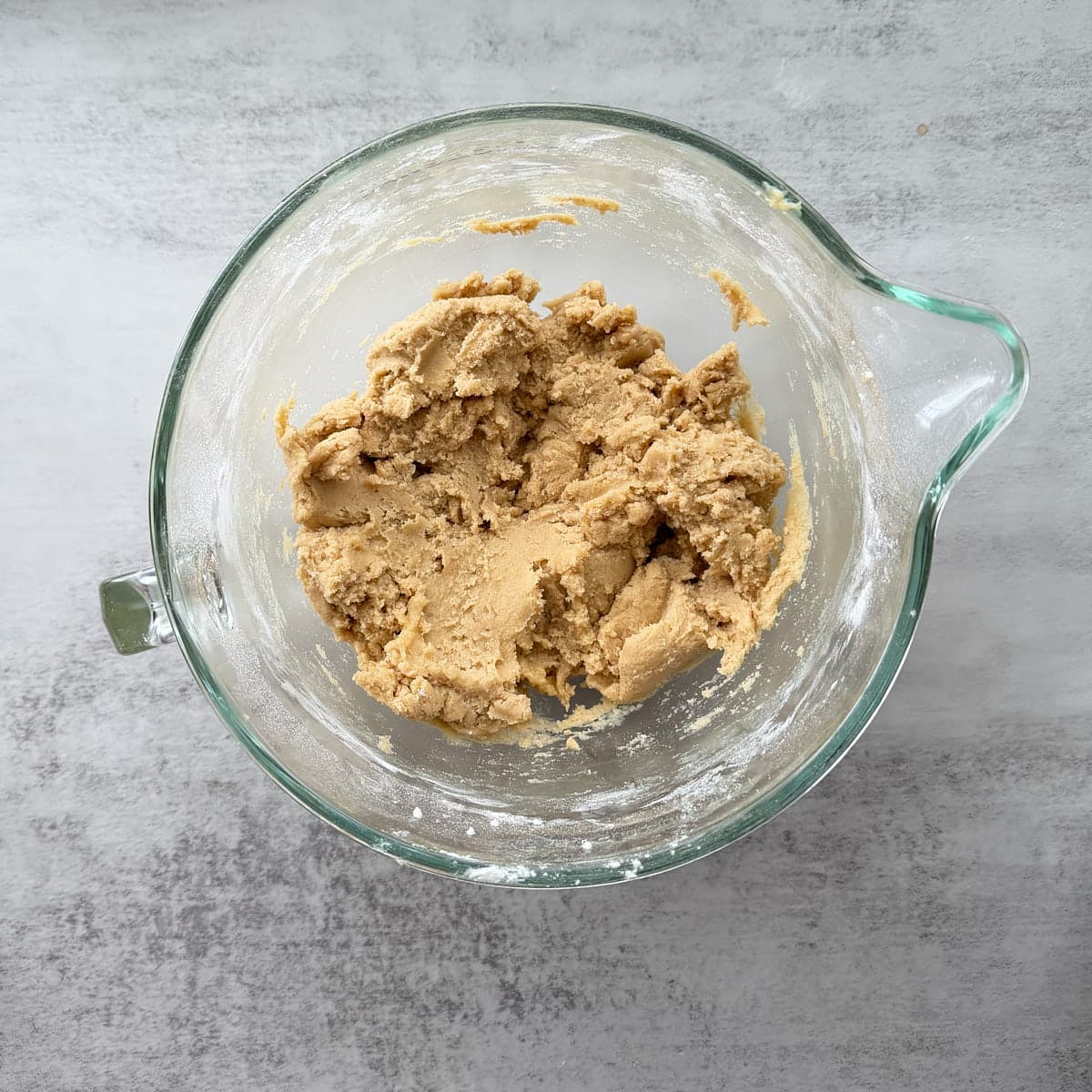 Dry ingredients added to Sourdough Snickerdoodle dough in a clear bowl.