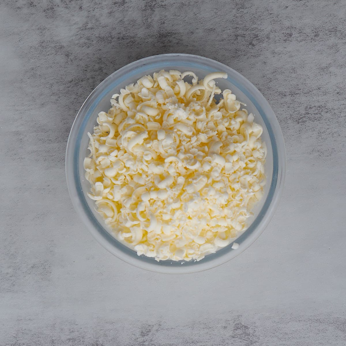 bowl of shredded frozen butter on a counter.