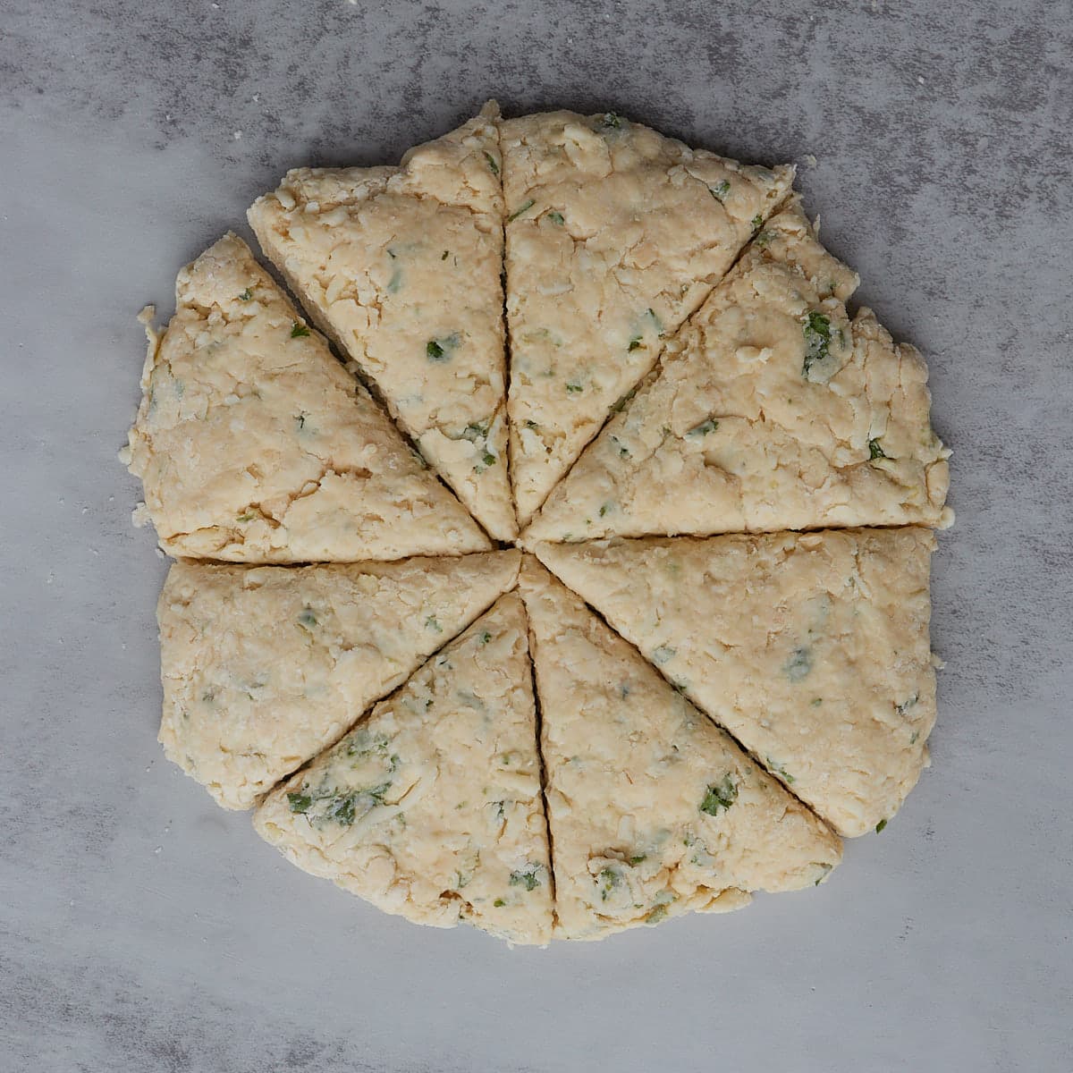 garlic scone dough shaped into flat round 8 inches and cut into 8 equal parts.