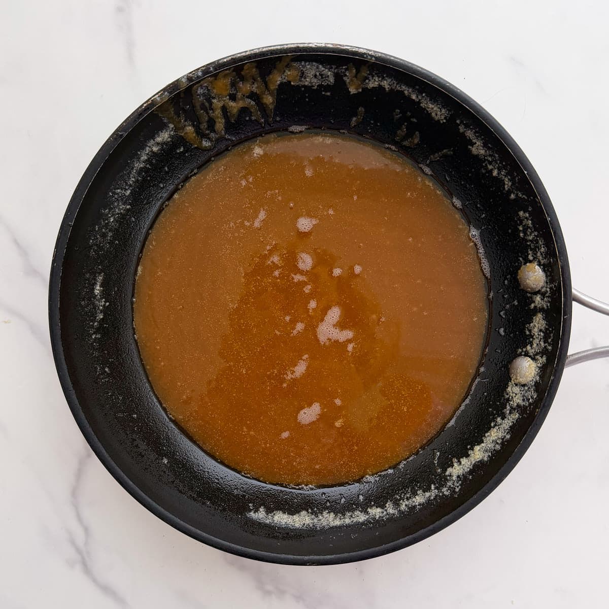 Small bowl of butter and brown sugar mixture to pour over sourdough monkey bread.