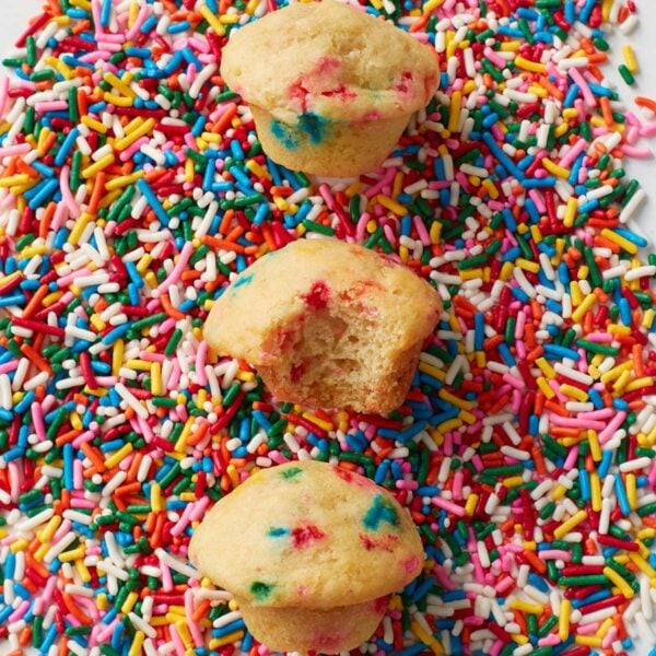 Three Sourdough Mini Muffins on a bed of sprinkles.