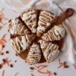 7 Sourdough Carrot Cake Scones arranged in a circle on a round wooden board.