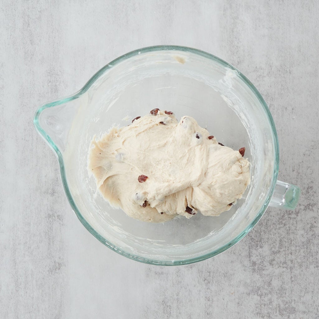 Dough for Sourdough Cinnamon Raisin Bread mixed in a clear mixing bowl.